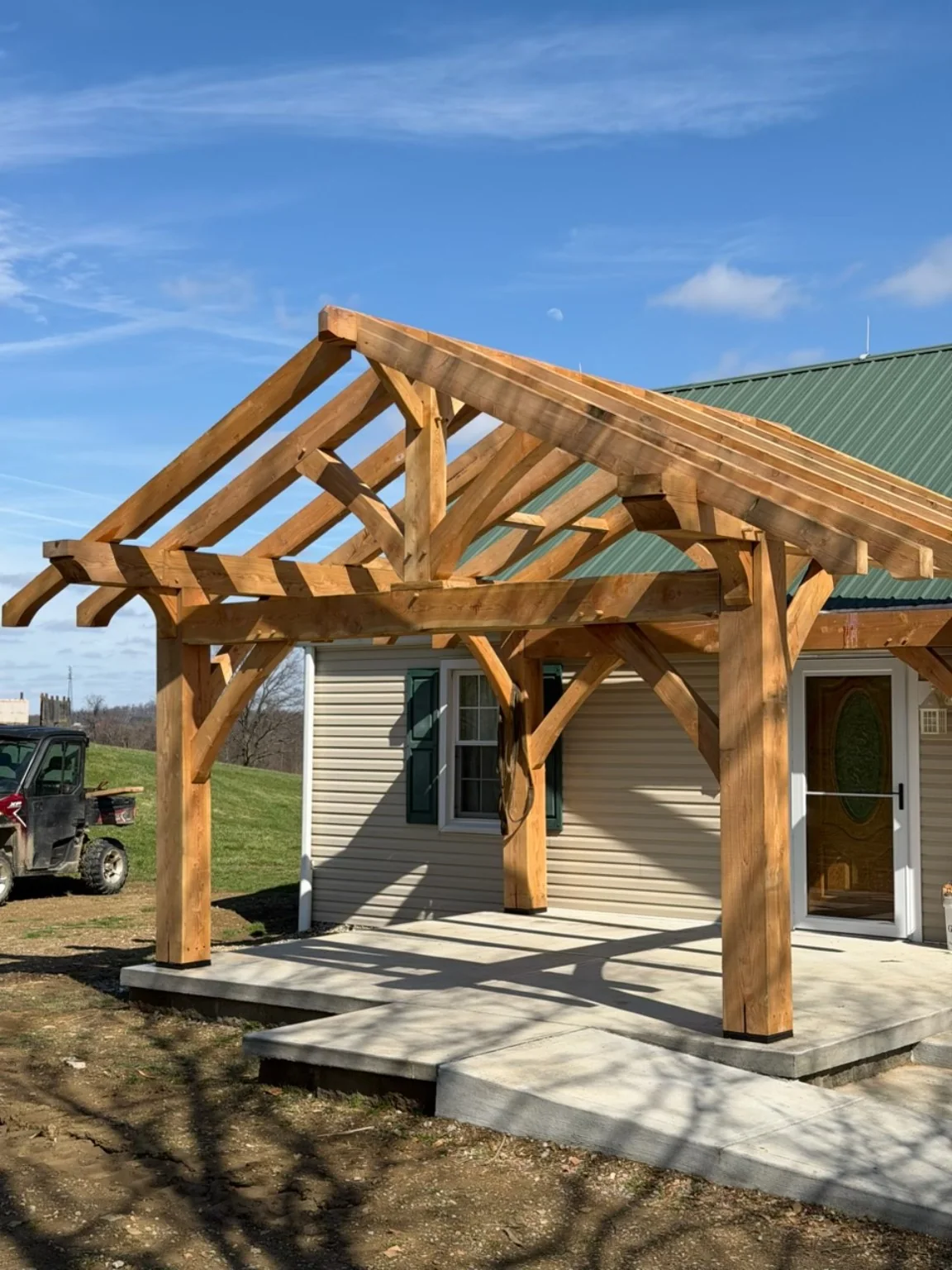Completed approximately 20-foot-wide hemlock timber-frame patio structure in Pittsburgh Pennsylvania